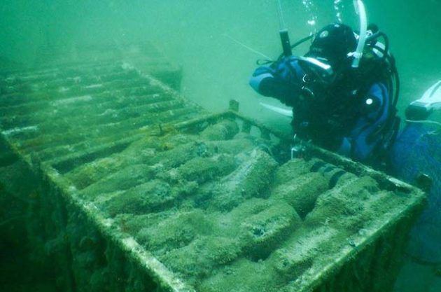 Ang diver sa ilalim ng tubig na may mga bote ng alak ng Wapisa.
